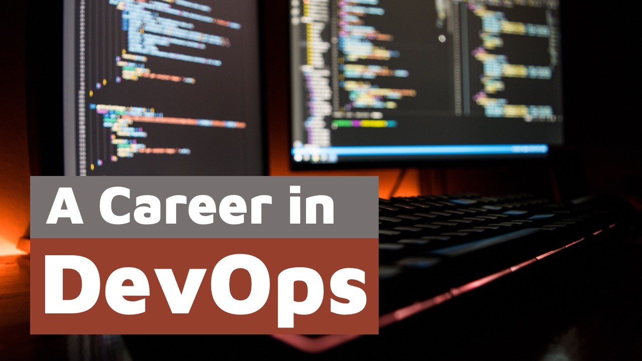 Two monitors displaying colorful code in a dark room, overlaid with the text 'A Career in DevOps'