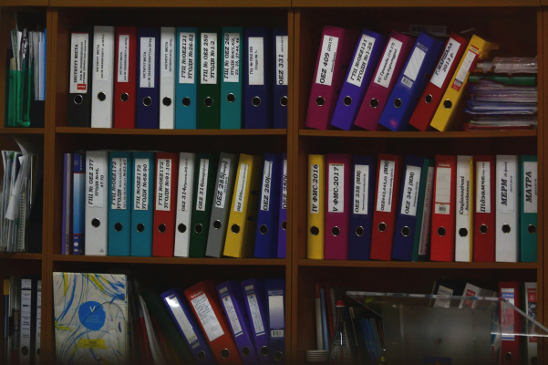 Colourful labelled binders on a shelf - organised, accessible documentation