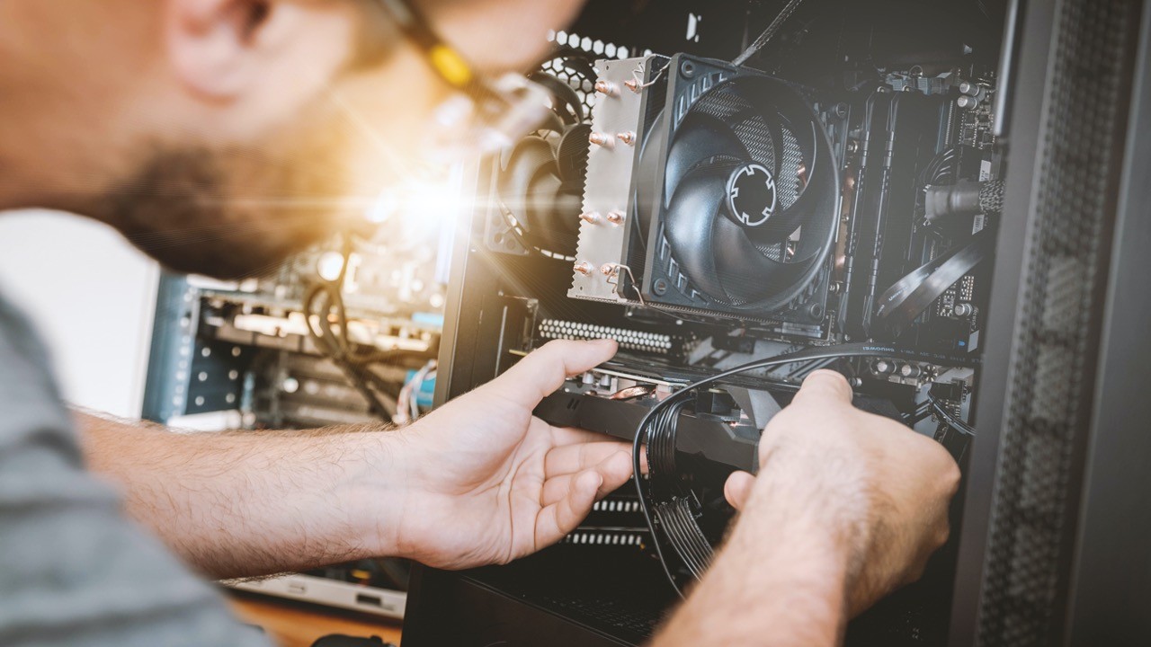 Engineer upgrading hardware inside a server - carefully fitting components together